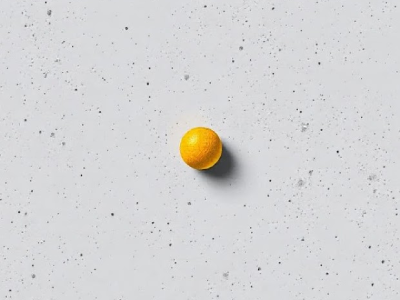 A single orange sphere centered on a speckled gray surface illustrating point as a fundamental design element