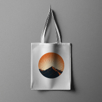A professional hanging white tote bag mockup featuring a circular mountain and sunset landscape graphic design illustration