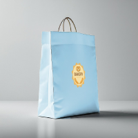 A professional light blue paper bag mockup featuring a gold bakery logo for retail food packaging branding